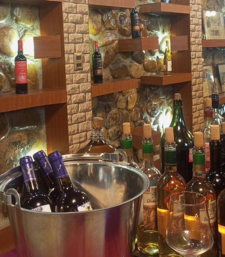 A flight of Tarija wines arranged on a wooden table