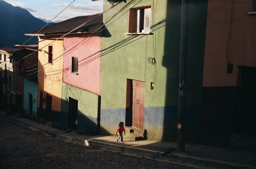 A child walks past colourful houses in Coroico, Bolivia