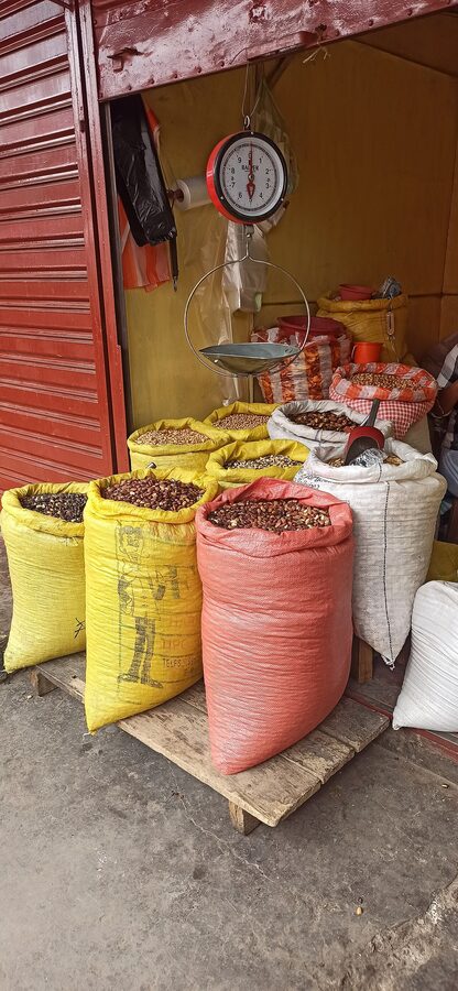 A vendor selling tostados (toasted corn) in a Cochabamba market