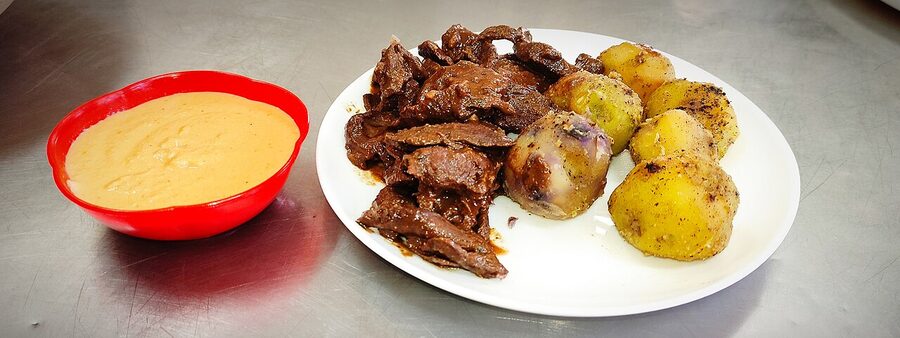 Anticucho paceño, beef heart skewers with potato and peanut sauce, La Paz