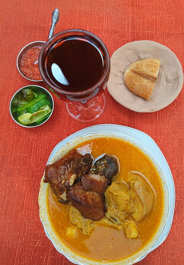 A bowl of fricasé, the yellow Bolivian pork and hominy soup, in La Paz