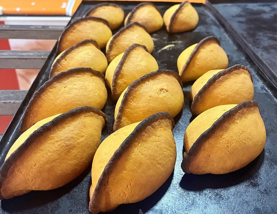 Bolivian salteñas, golden baked, on a plate in Santa Cruz