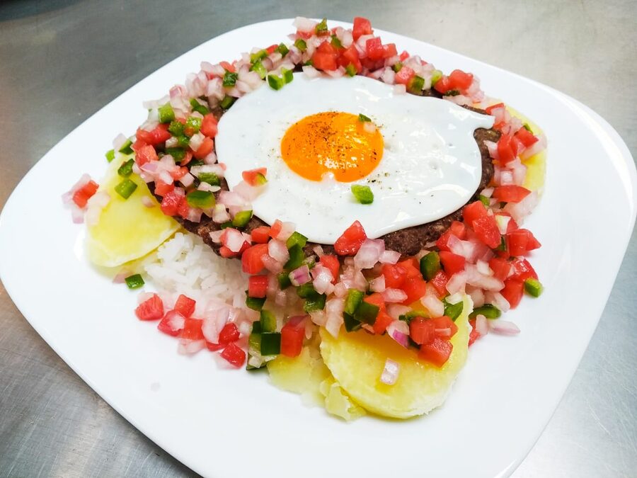 Silpancho cochabambino, the layered Bolivian rice and beef plate