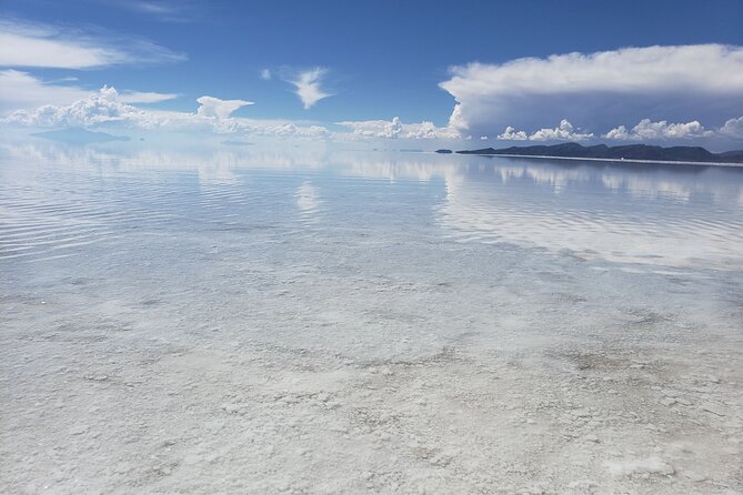 Salar de Uyuni tours 1 day - Playa Blanca and the flags add human markers